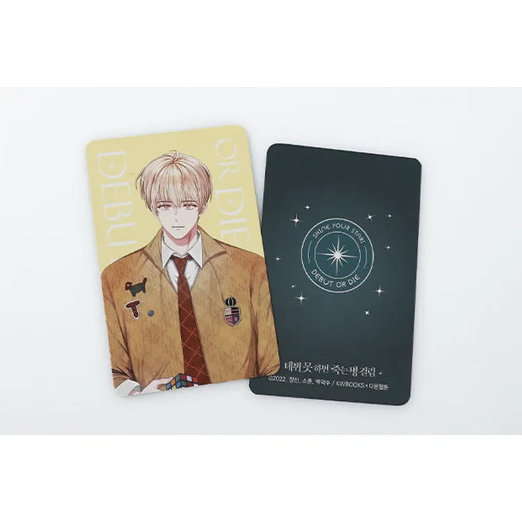 Debut Or Die Photo Card Set featuring illustrated character card with beige background and decorative black card