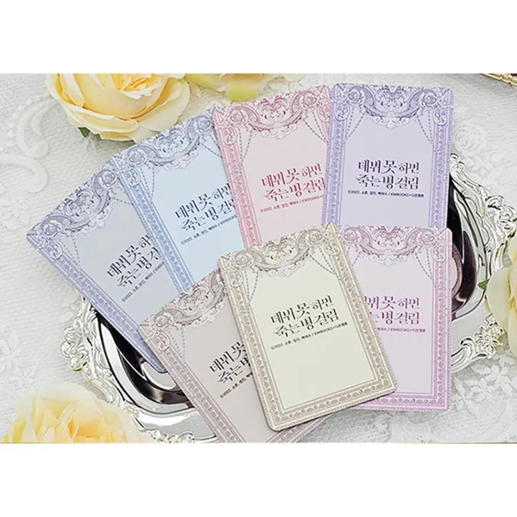 Debut Or Die Photocard Set featuring multiple pastel-colored ornate cards displayed on a silver tray