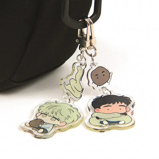 The Sacred Serpent's Seduction Acrylic Keychain attached to bag handle