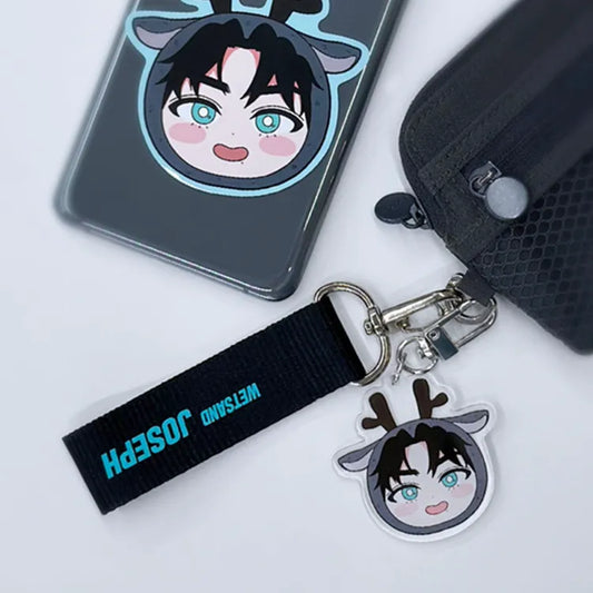 Wet Sand keychain featuring Joseph in SD character form, attached to a bag with a matching name strap keyring.